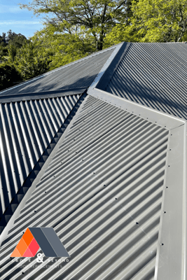 A Close Up Of A Metal Roof With Trees In The Background – Melbourne, VIC - Above & Beyond Roof Replacements