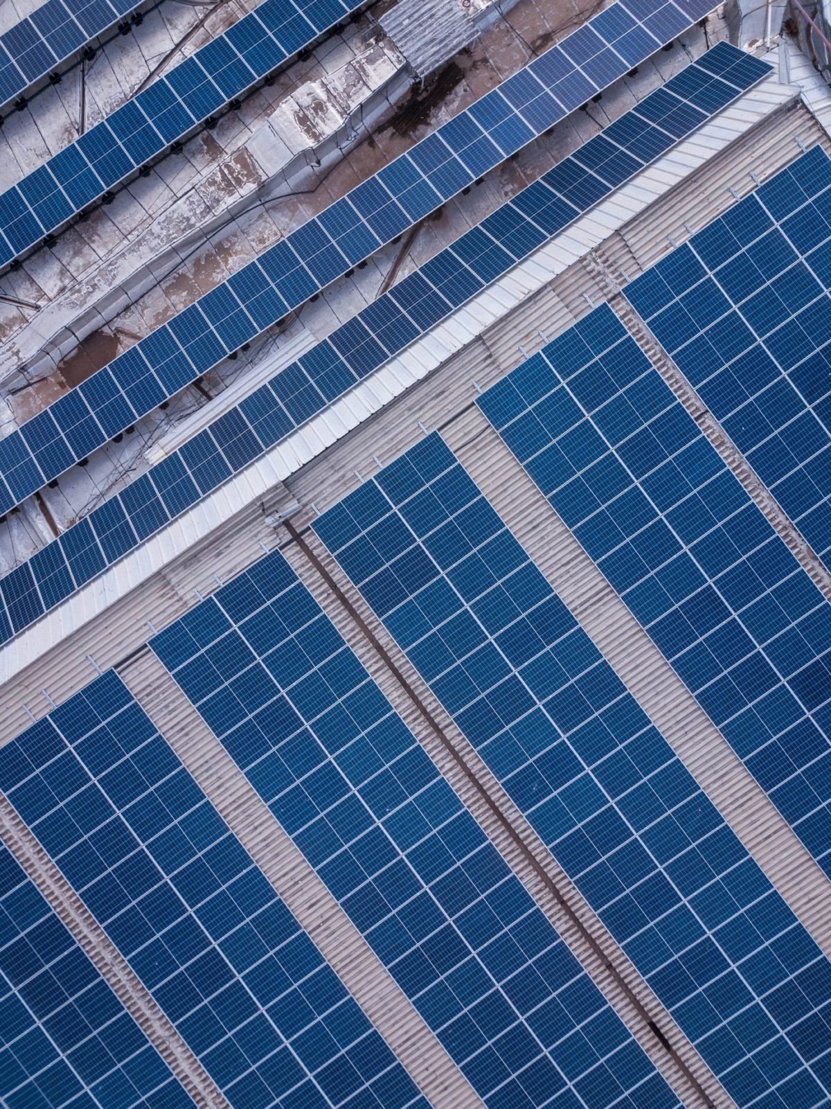 An Aerial View Of A Row Of Solar Panels On The Roof Of A Building – Melbourne, VIC - Above & Beyond Roof Replacements