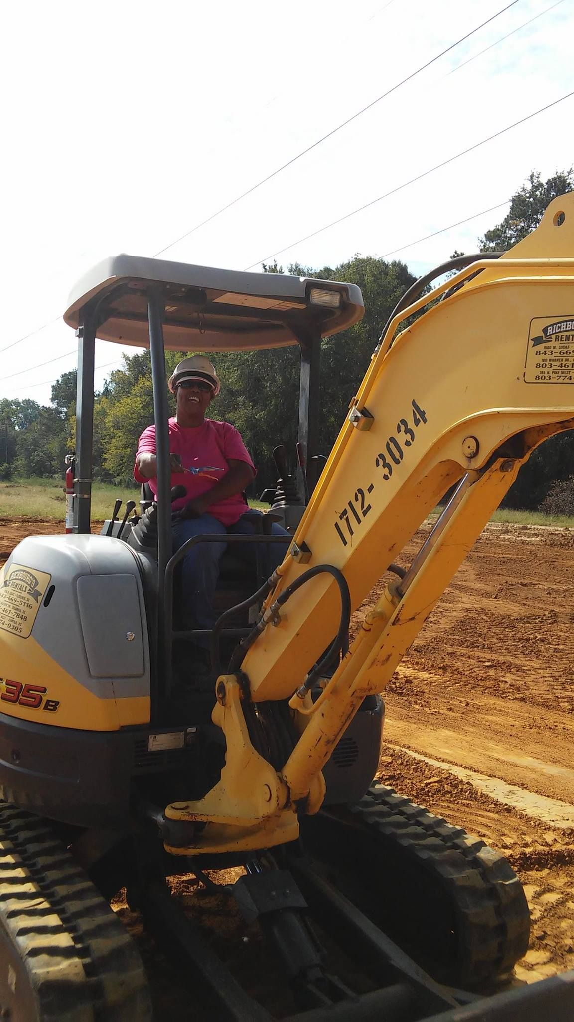 Debra Pearson Owner of G&P Construction is driving a yellow excavator