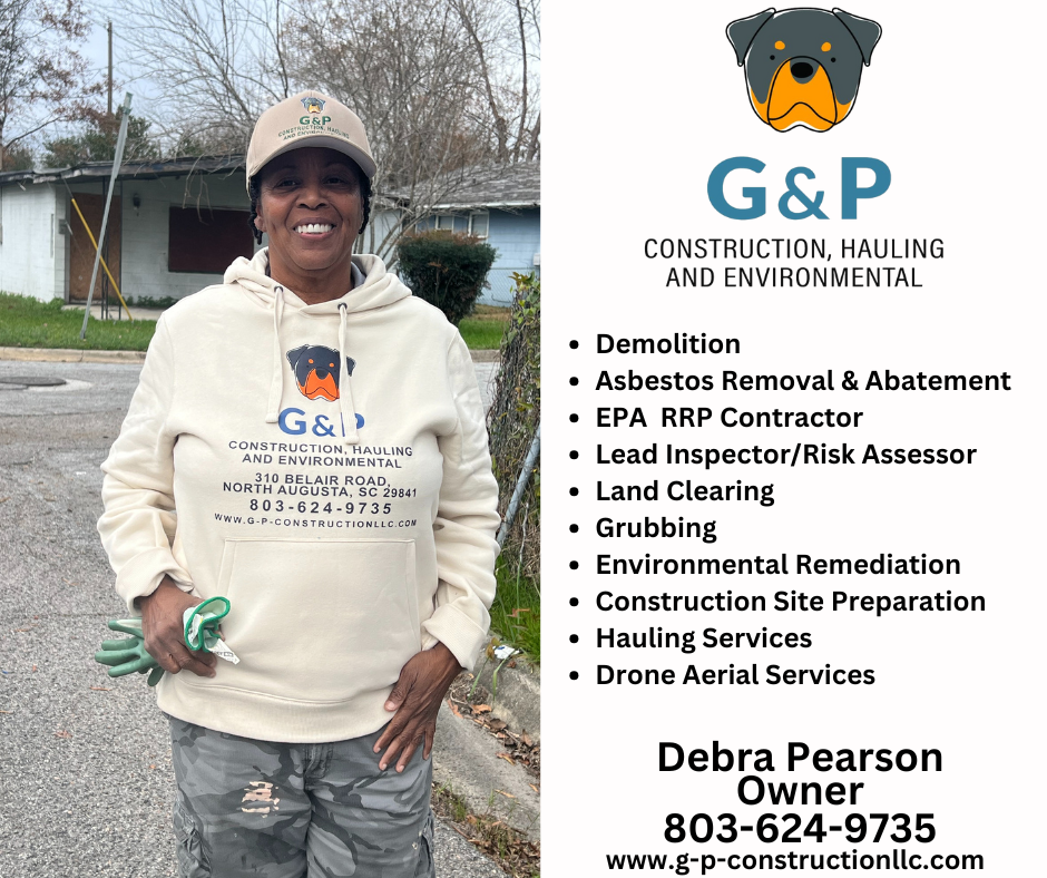 Debra Pearson, owner of G&P construction is standing in front of a house wearing a g & p hoodie.