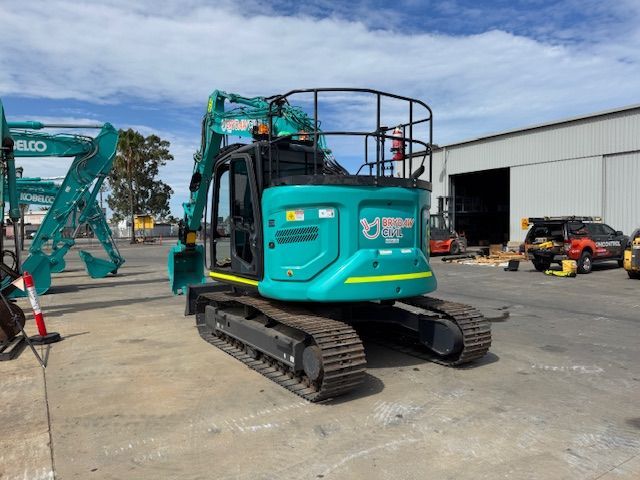 Orange ACE backhoe loader on display outdoors.