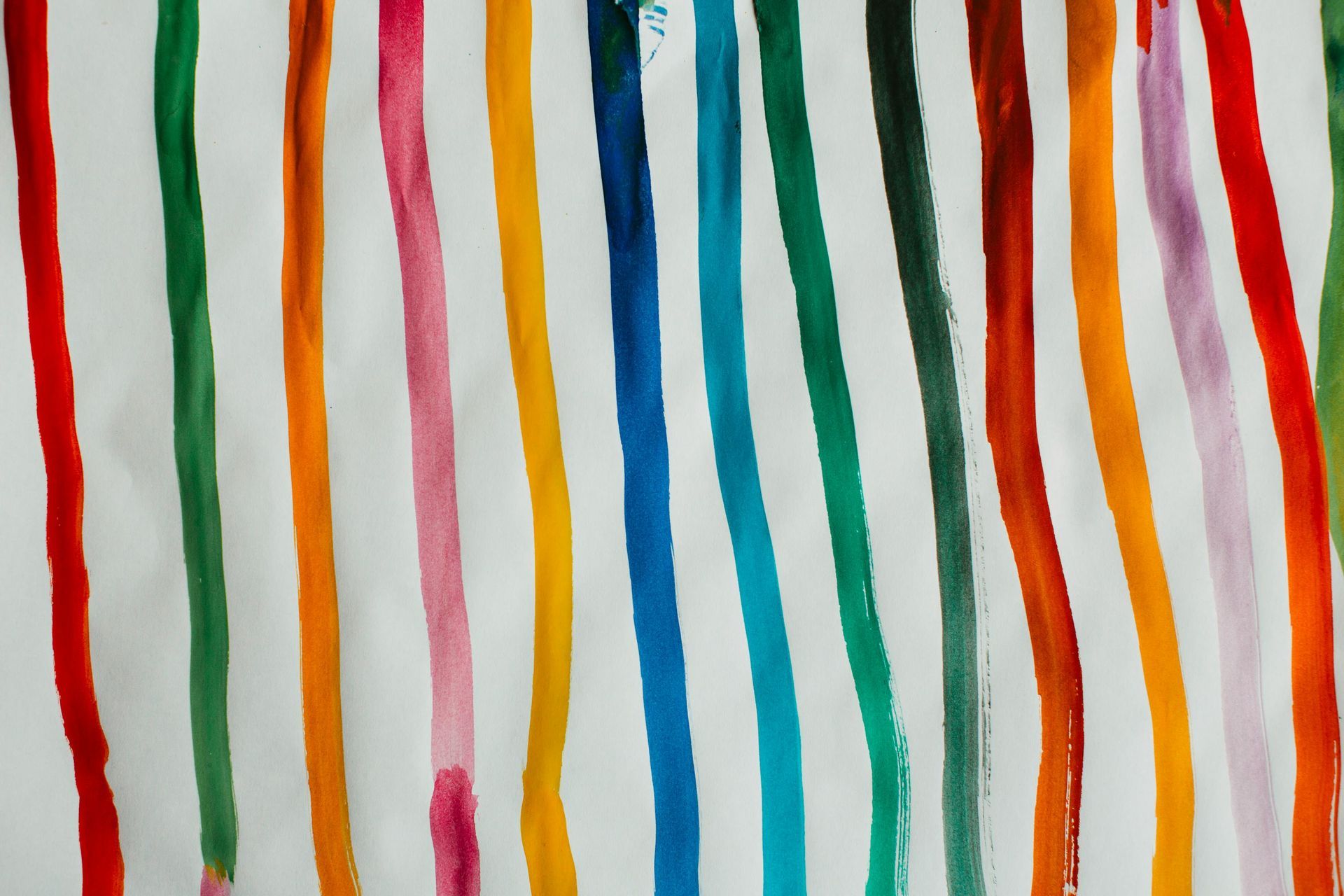 Vertical stripes in varying colors of paint on white background.