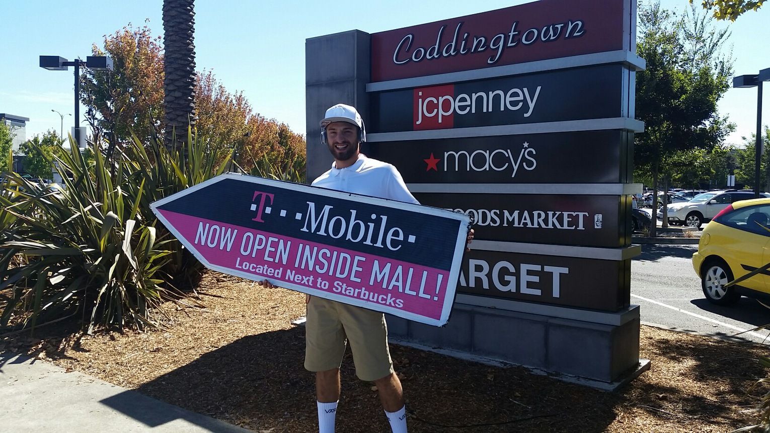 A man is holding a sign that says