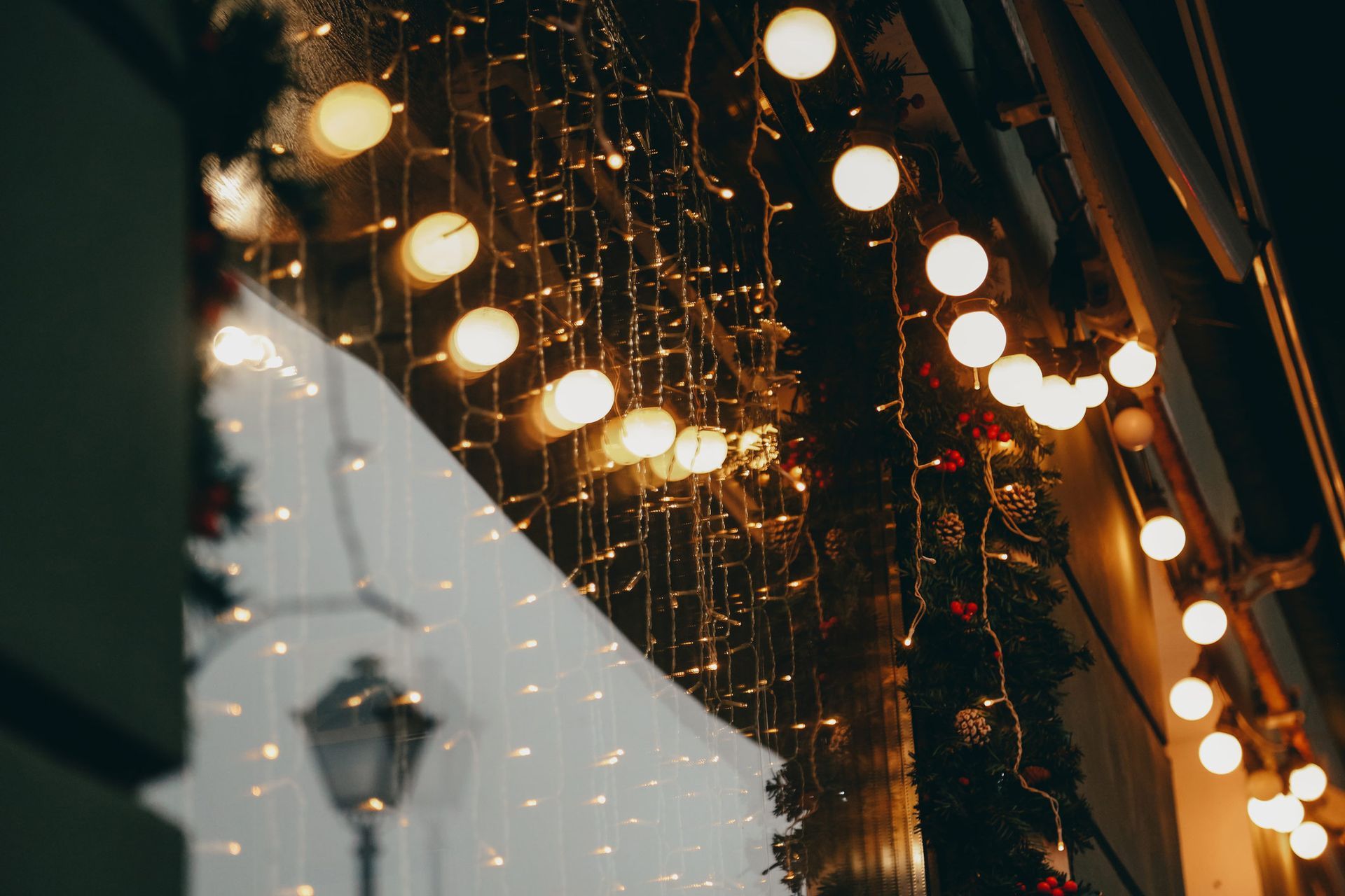 Full-frame small shop exterior festively decorated with glittering garlands