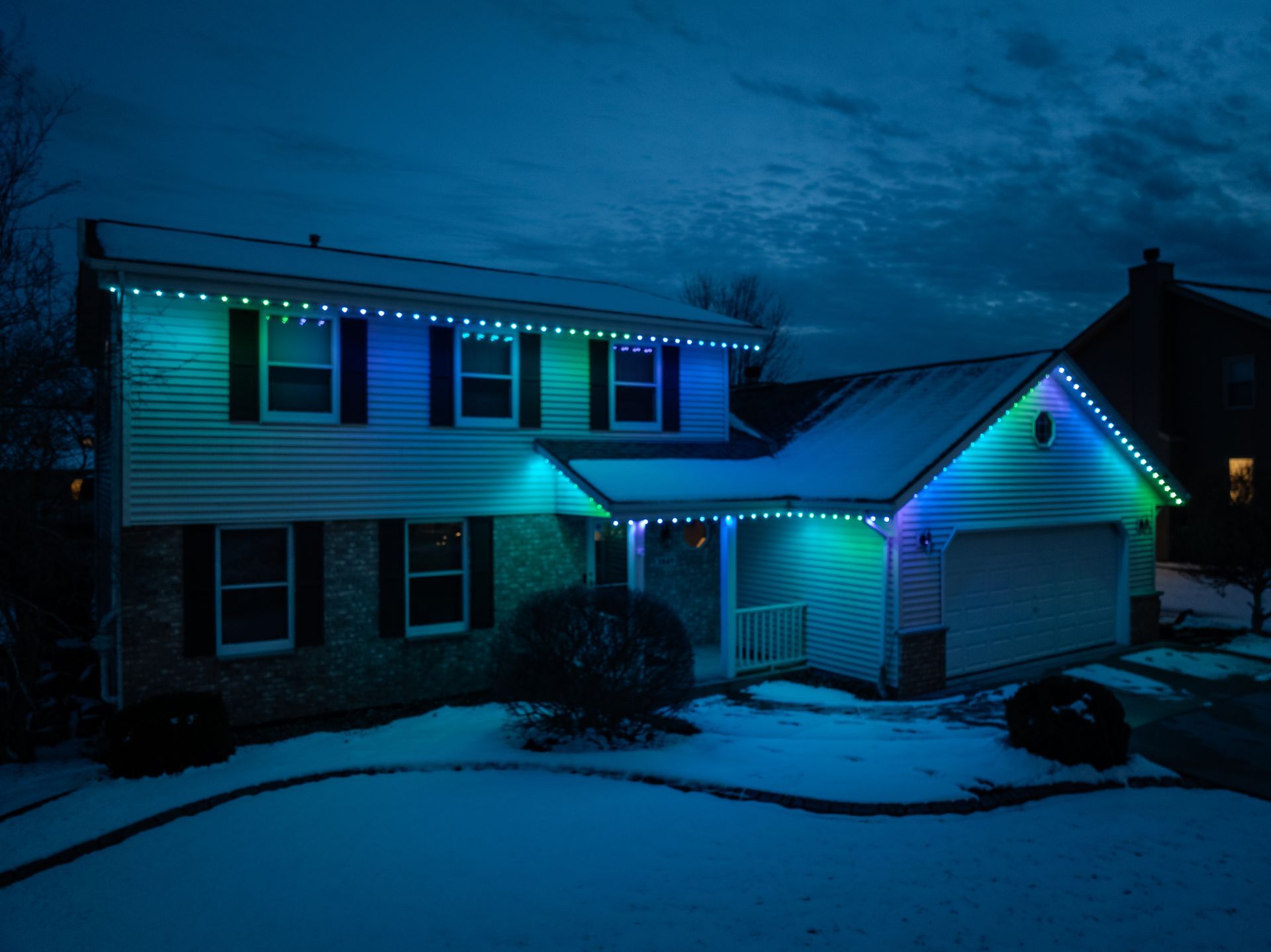 A house with blue and white christmas lights on it