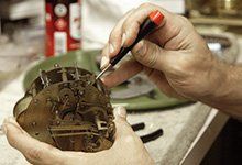 Clock Tools — Clock Being Fixed By Worker in Wayland, MA