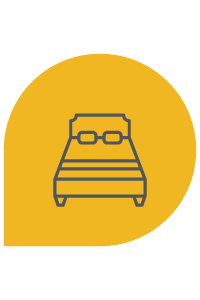 Icono de cama en una burbuja de diálogo amarilla.