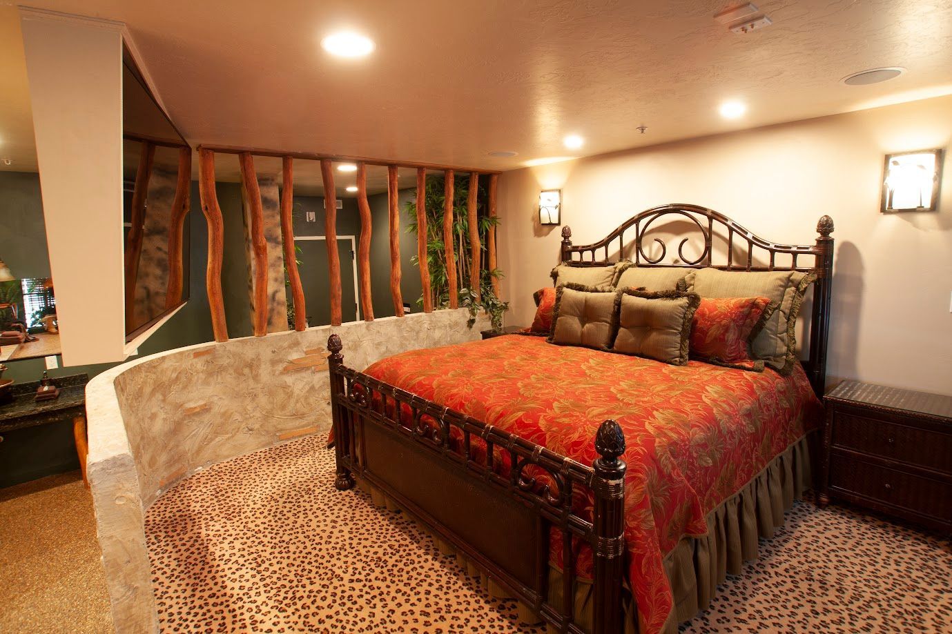 A bedroom with a large bed and a leopard print carpet