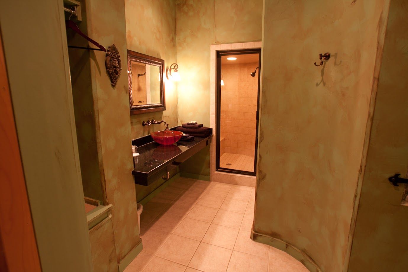 A bathroom with two sinks , a mirror and a shower.