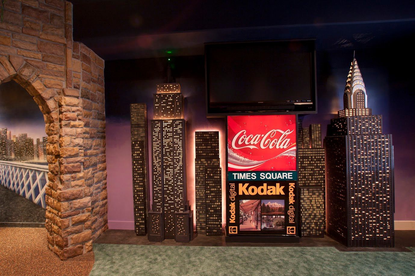 A room with a coca cola sign and a kodak sign