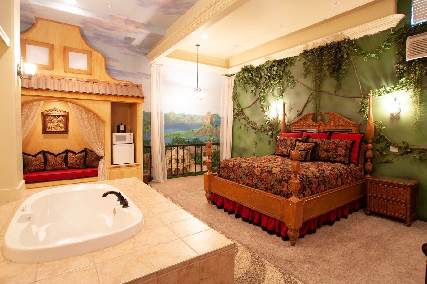 A bedroom with a large bed and a jacuzzi tub.