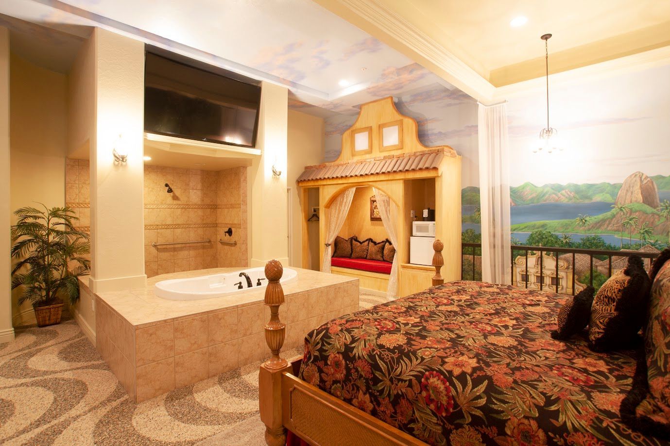 A bedroom with a large bed and a bathtub.