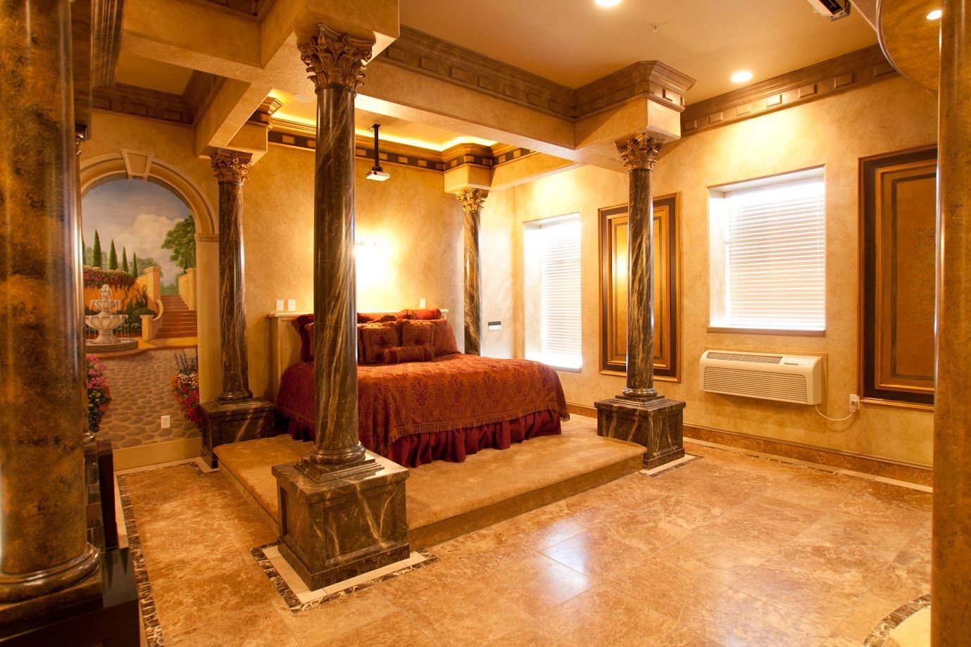 A bedroom with a canopy bed surrounded by columns and a painting on the wall.