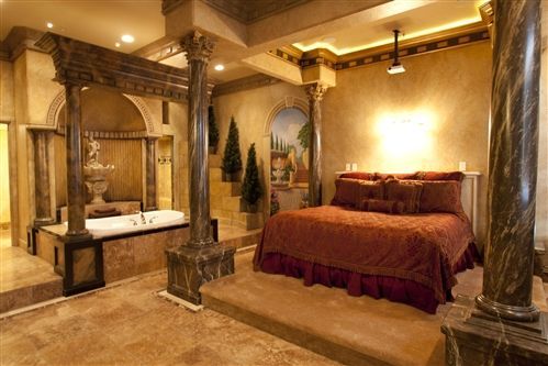 A bedroom with a large bed and a bathtub