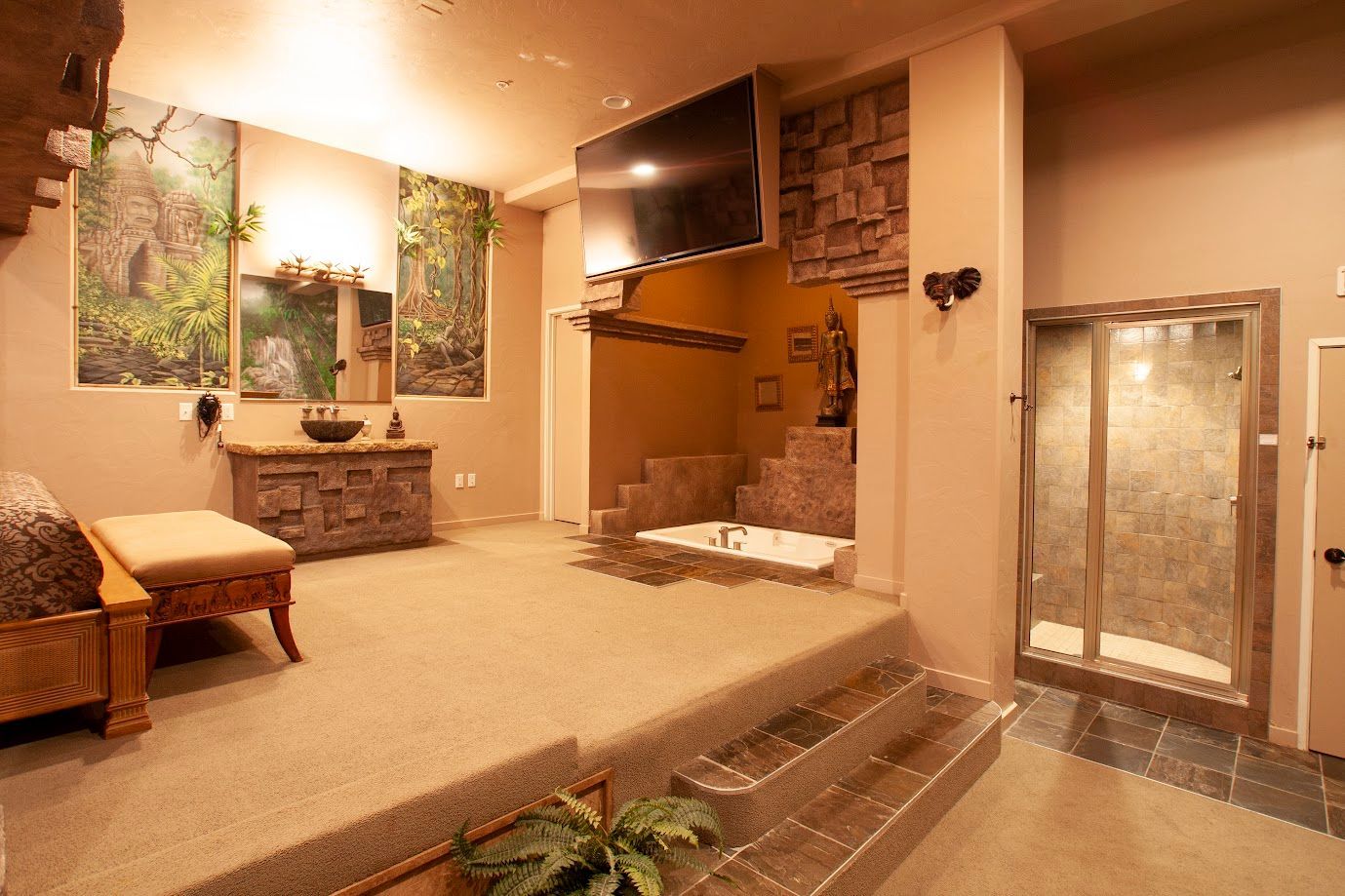 A bathroom with a bathtub and a walk in shower.