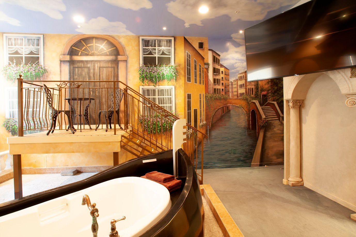 A bathroom with a bathtub and a painting on the wall