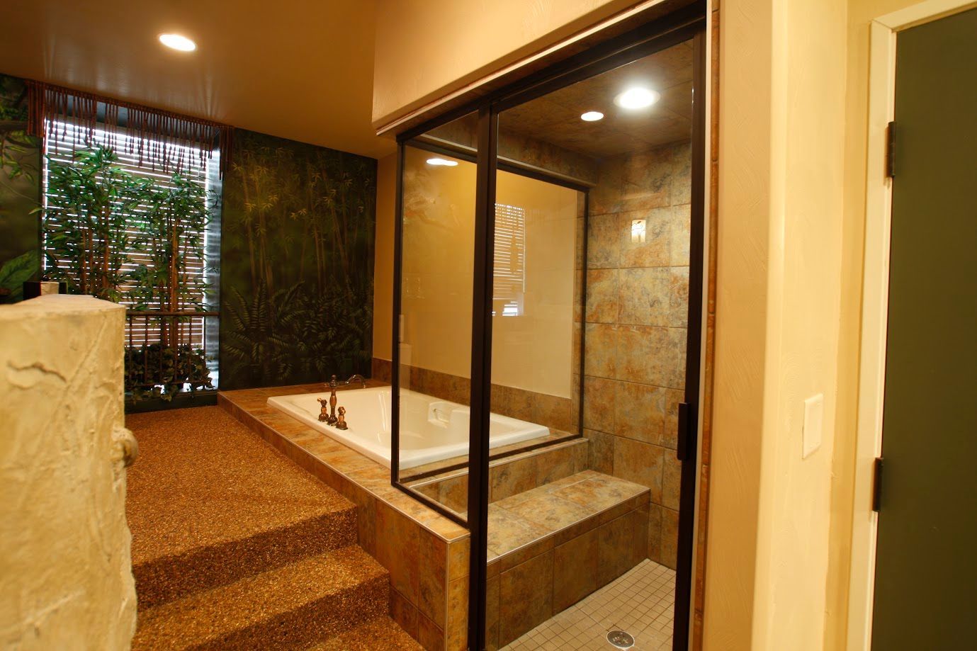 A bathroom with a jacuzzi tub and a sliding glass door.