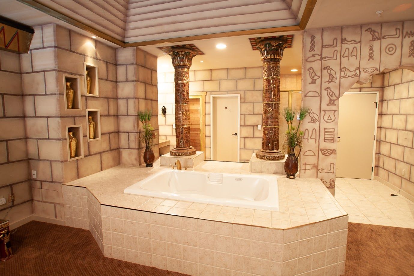 A bathtub in a bathroom with a brick wall