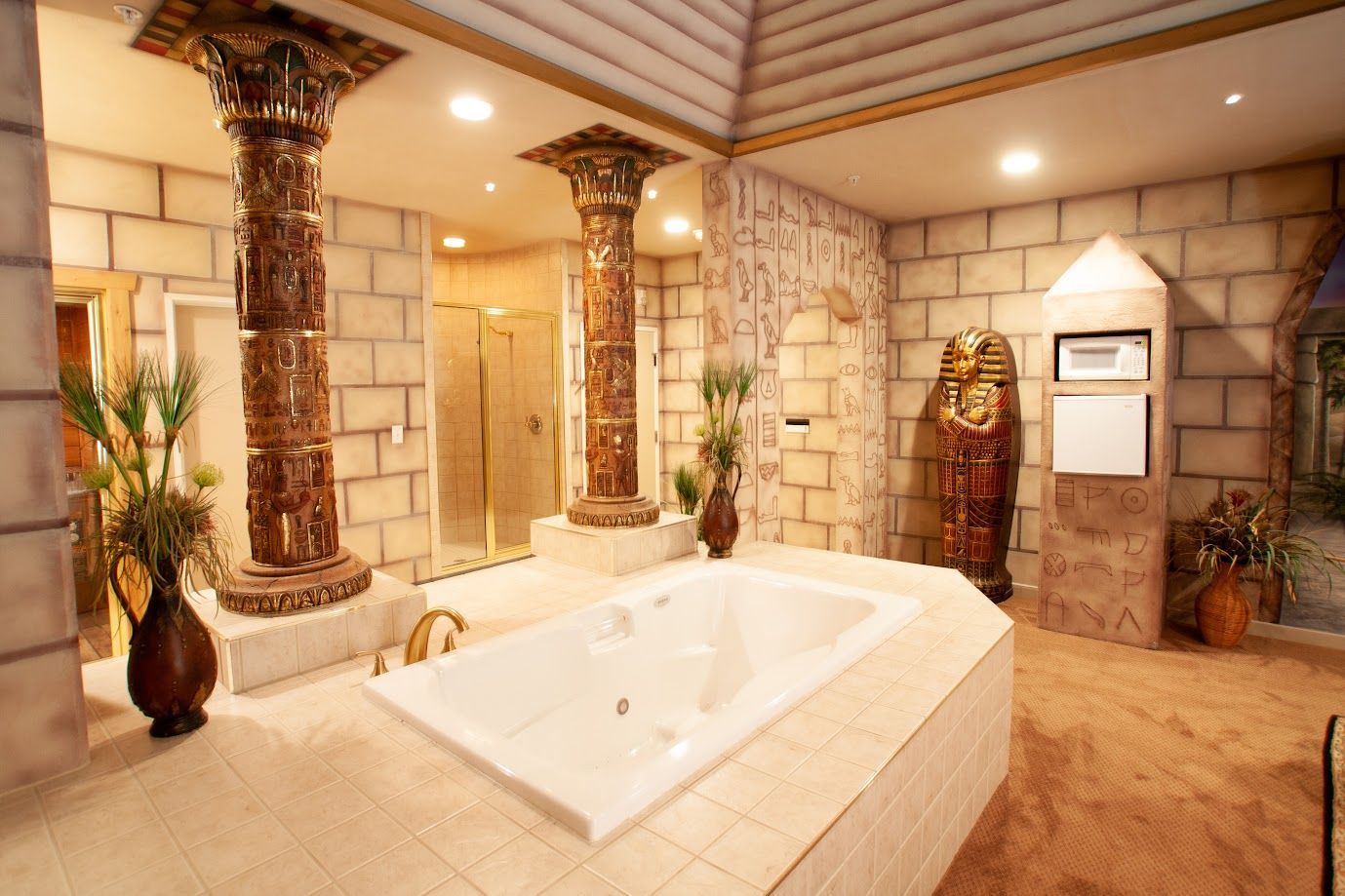 A bathroom with a jacuzzi tub and columns