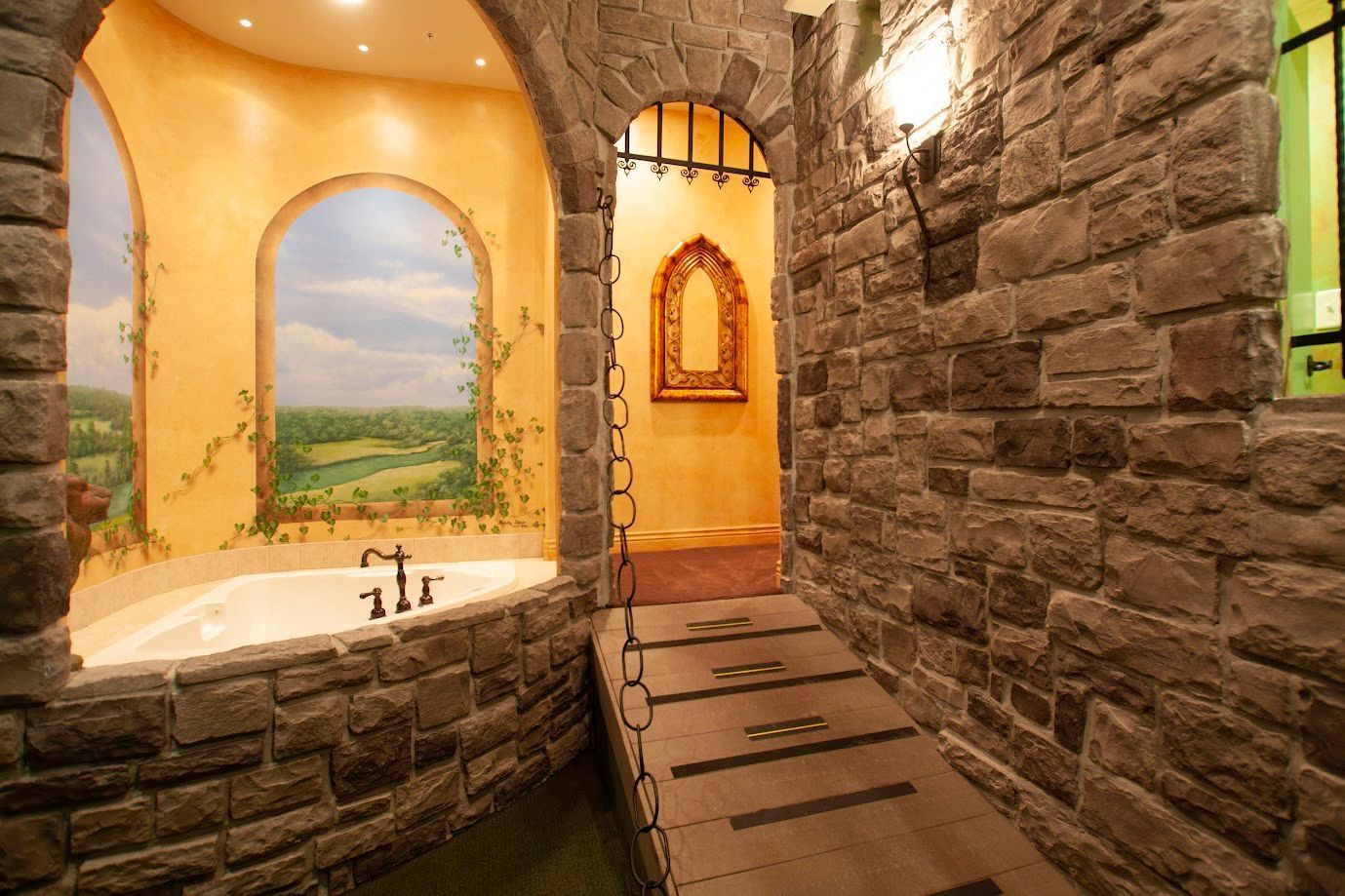 A bathroom with a bathtub and a painting on the wall.