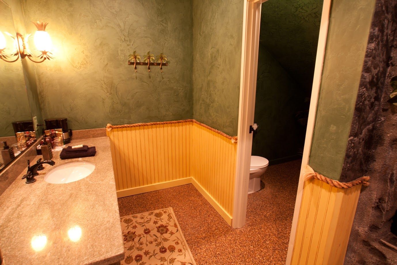 A bathroom with a sink , toilet and mirror.