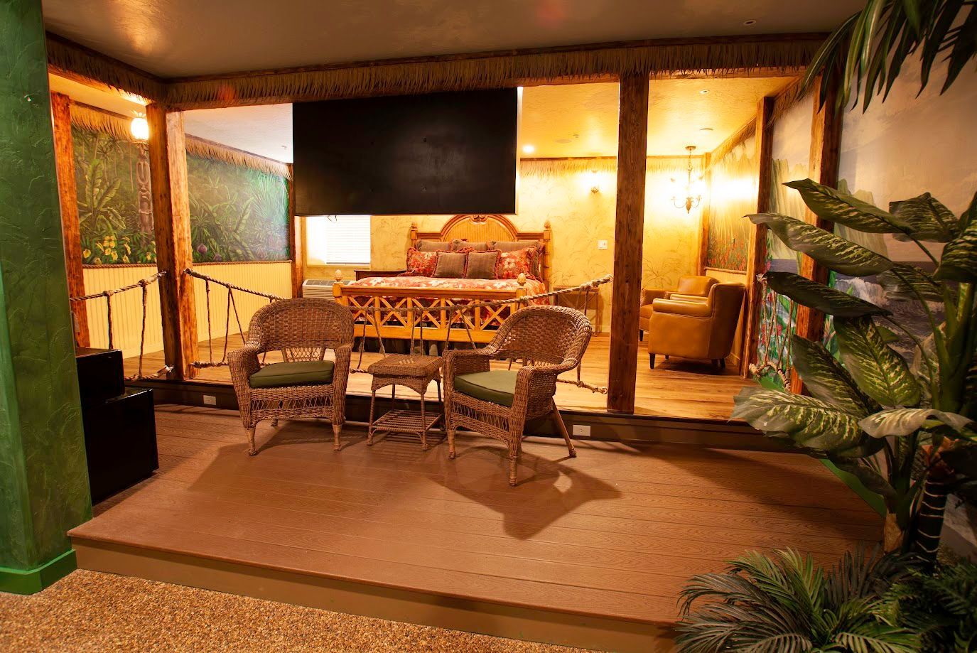 A living room with a couch , chairs , table and television.