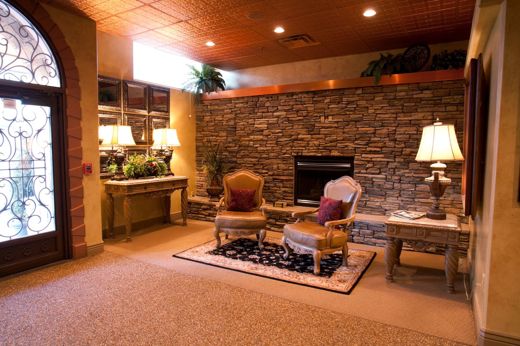 A living room with a fireplace and two chairs