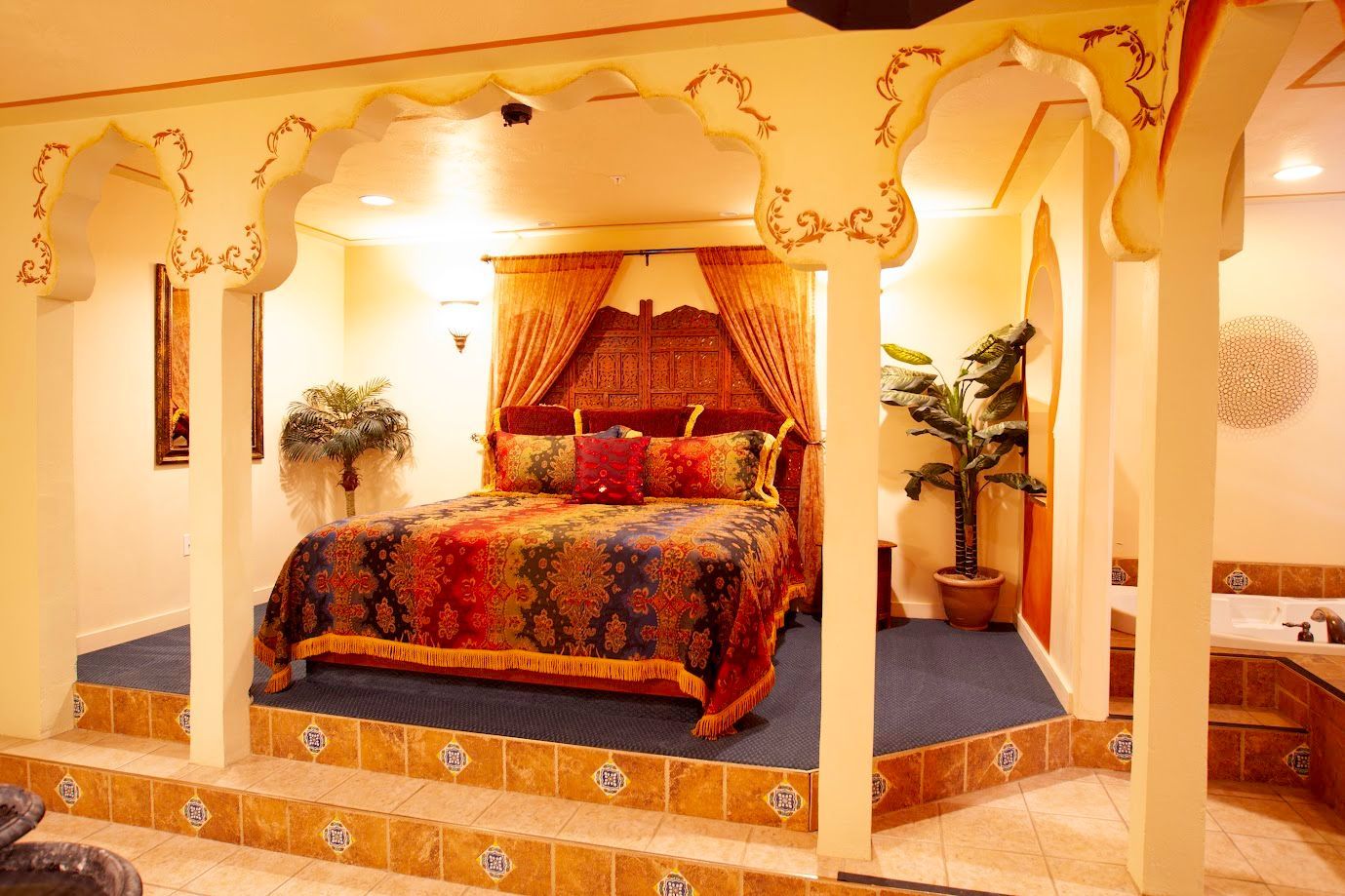 A bedroom with a canopy bed and a bathtub