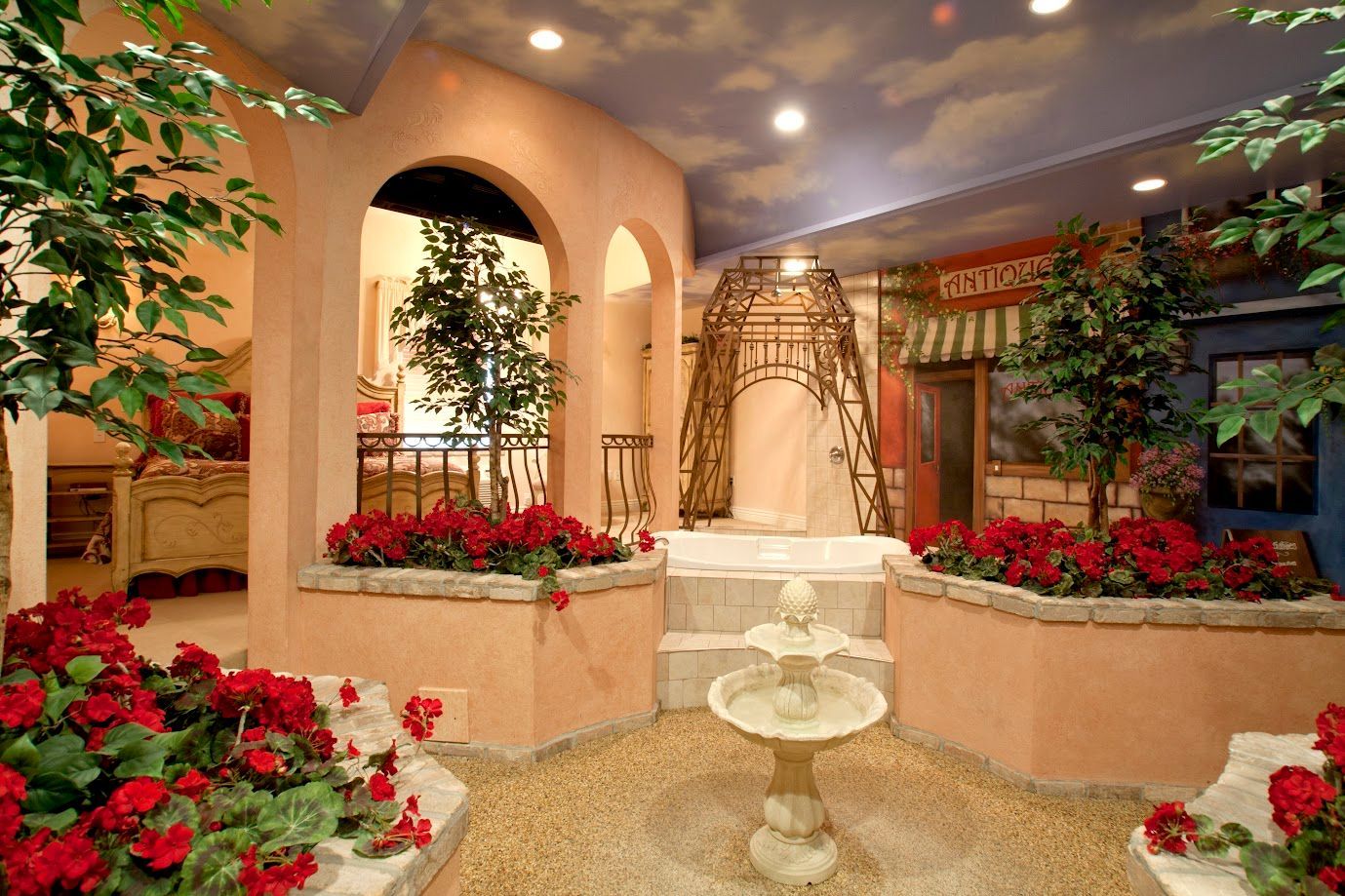 There is a fountain in the middle of the room surrounded by flowers.