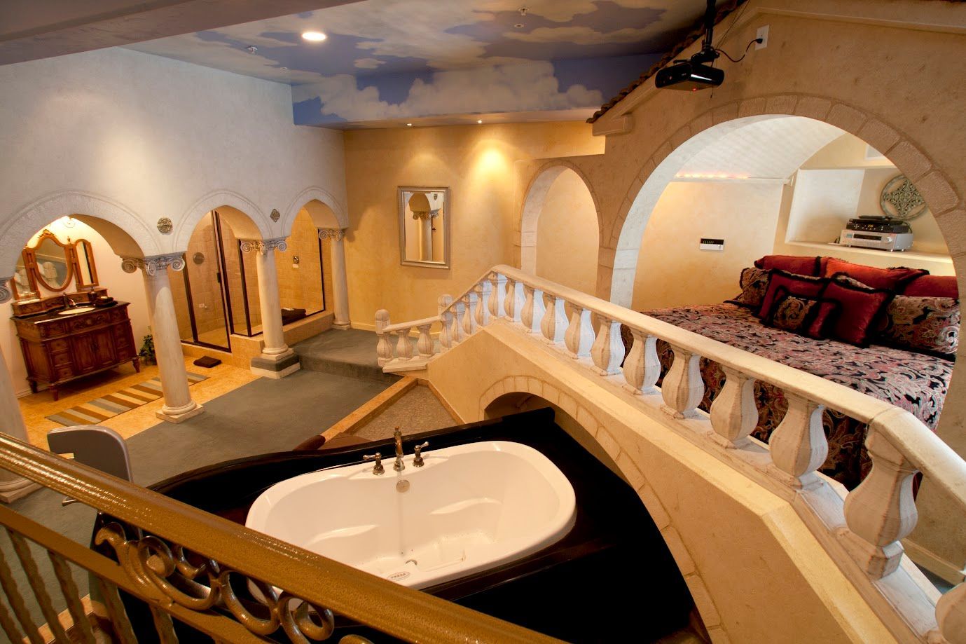 A large bathtub is in the middle of a large room