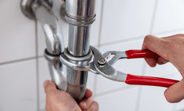 Hands holding wrench tightening pipe - Handyman Neenah wi