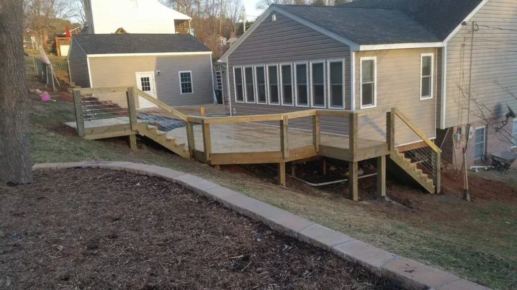 A house with a wooden deck in front of it