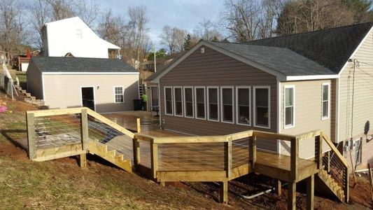A house with a wooden deck in front of it