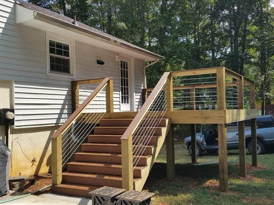 A house with a wooden deck and stairs leading up to it