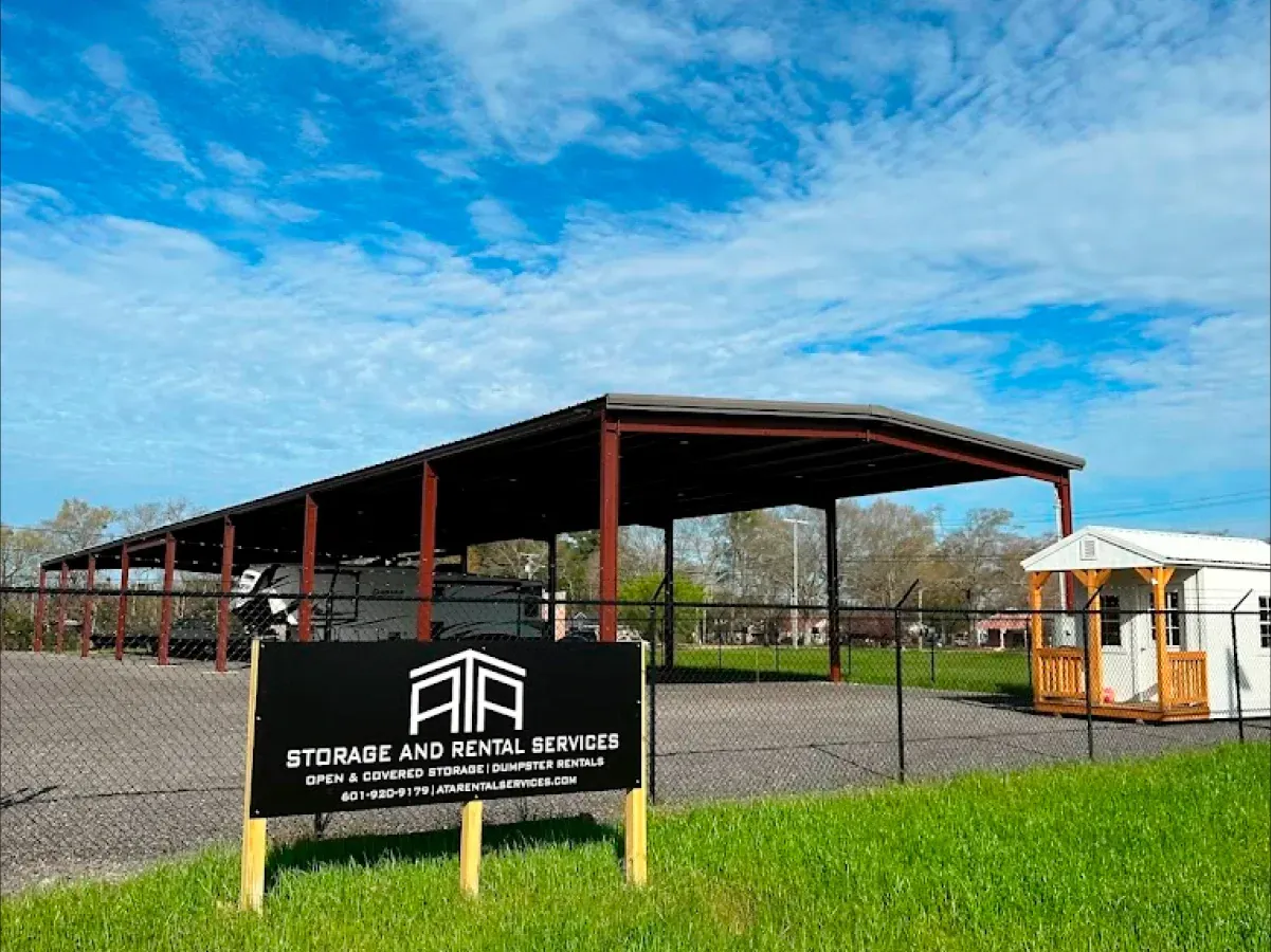 A large metal structure with a sign in front of it.