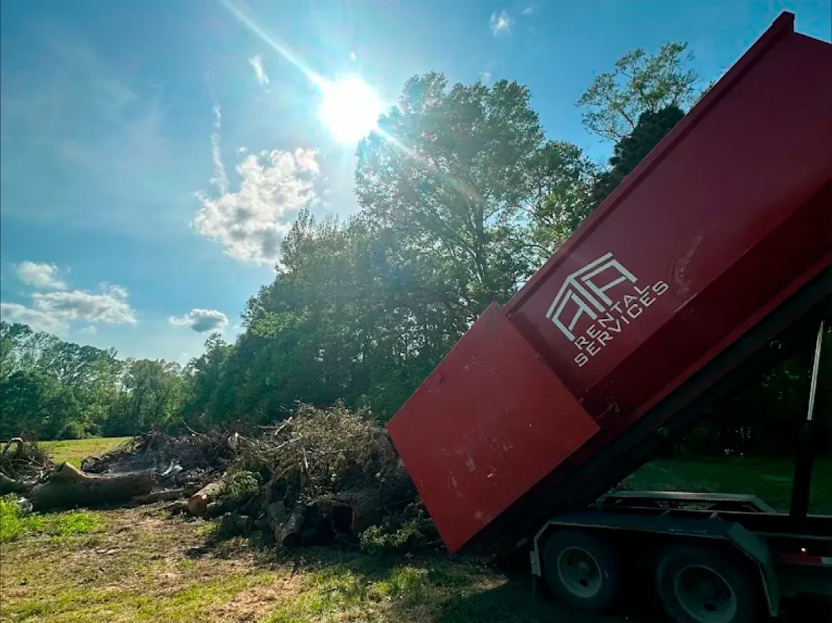 A red dumpster with the letters ar on it