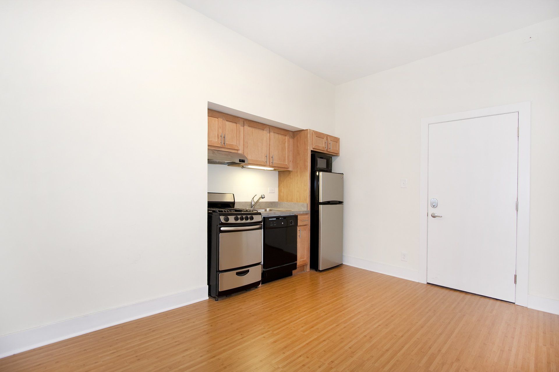 Kitchen and living room at Reside at 2525 in Chicago, IL.