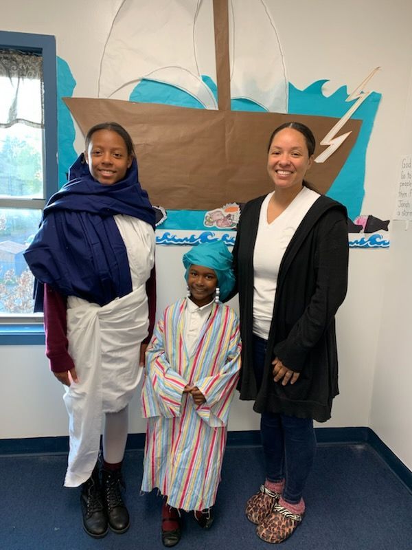 Children wearing costume with their parents