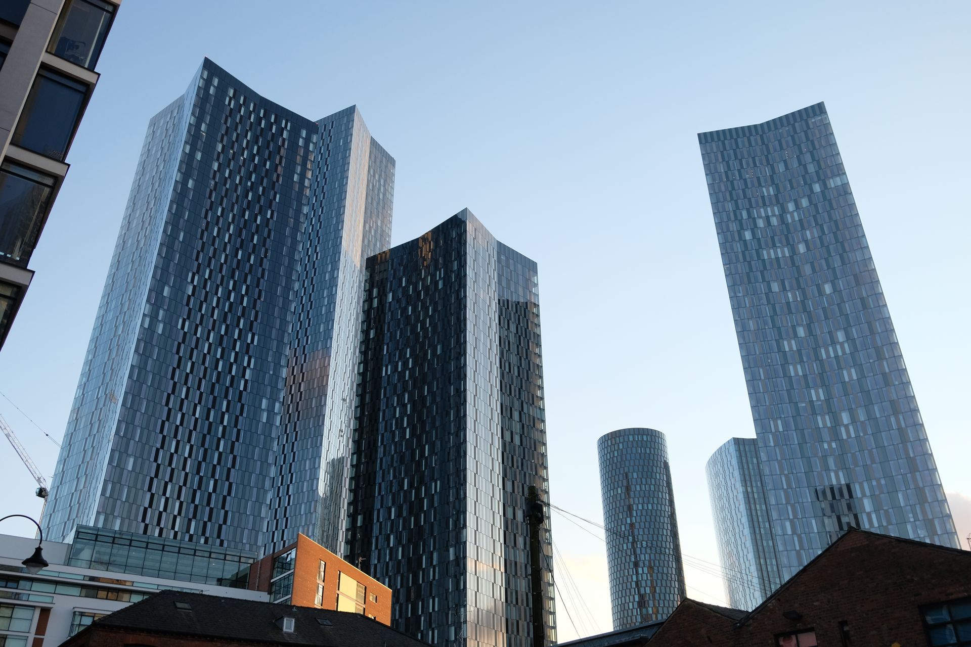 Skyscrapers against a blue sky, in an urban setting.
