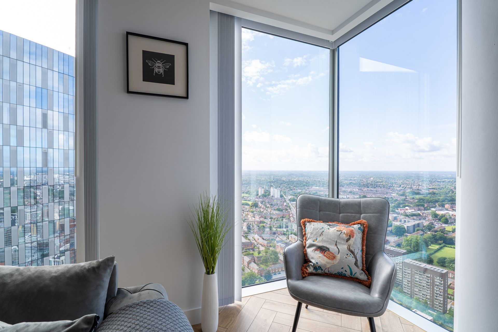 Entrance hall: A long hallway with a white floor and dark walls leads to glass doors. Brick walls on either side.
