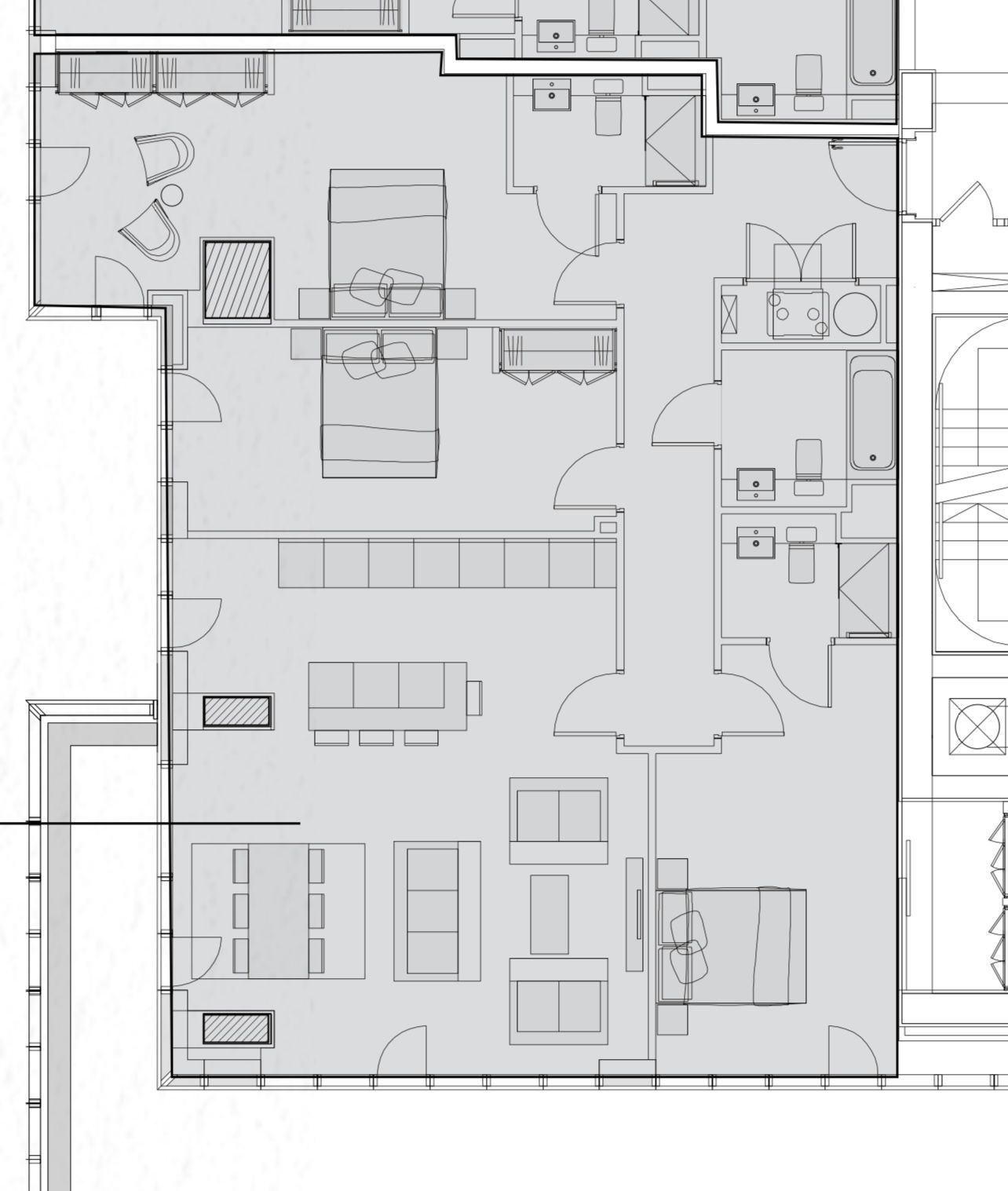 Floor plan of a building layout with rooms, furniture, and fixtures; gray scale.