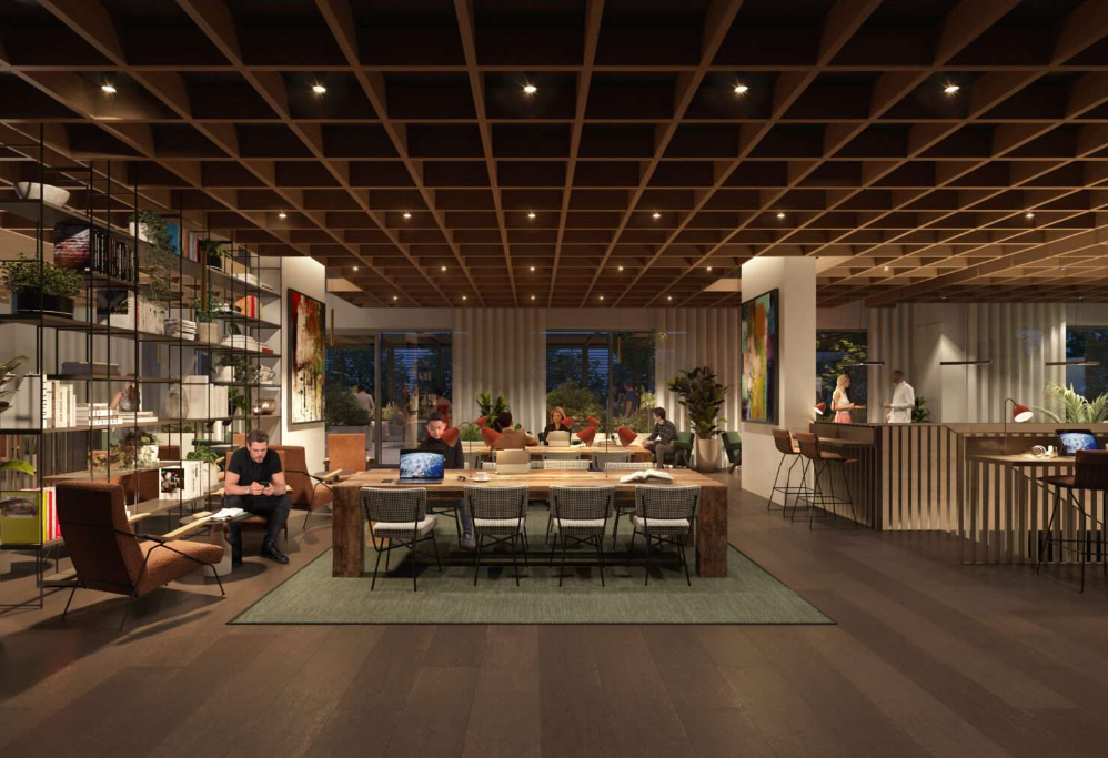Interior co-working space with wooden ceiling, bookshelves, and people working.