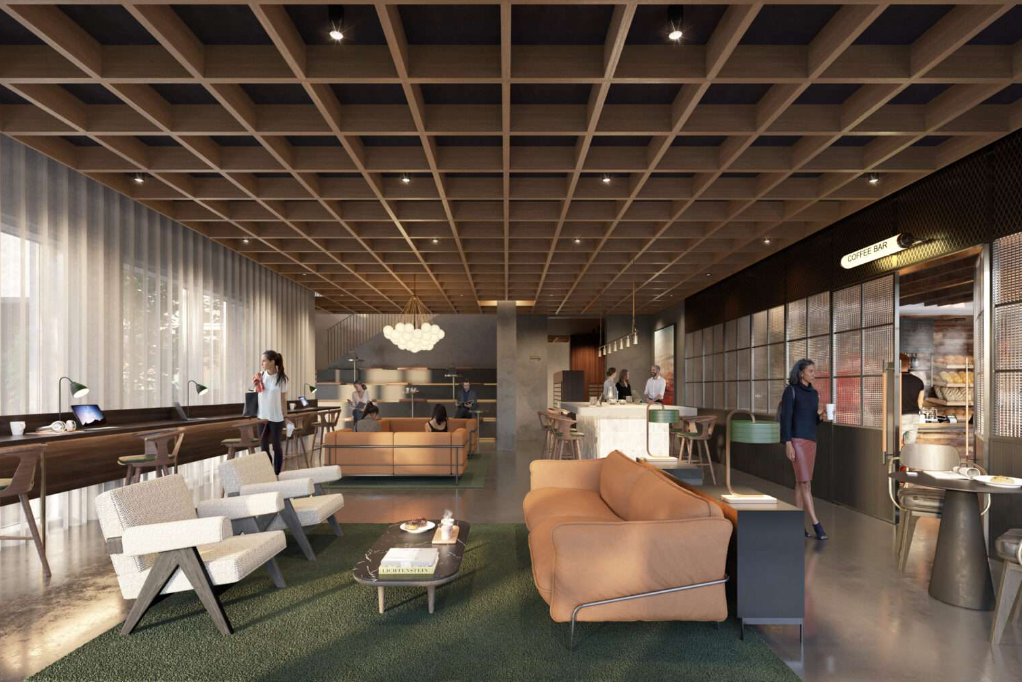 Modern lobby with wood ceiling grid, seating, and a bar area. People are walking around.