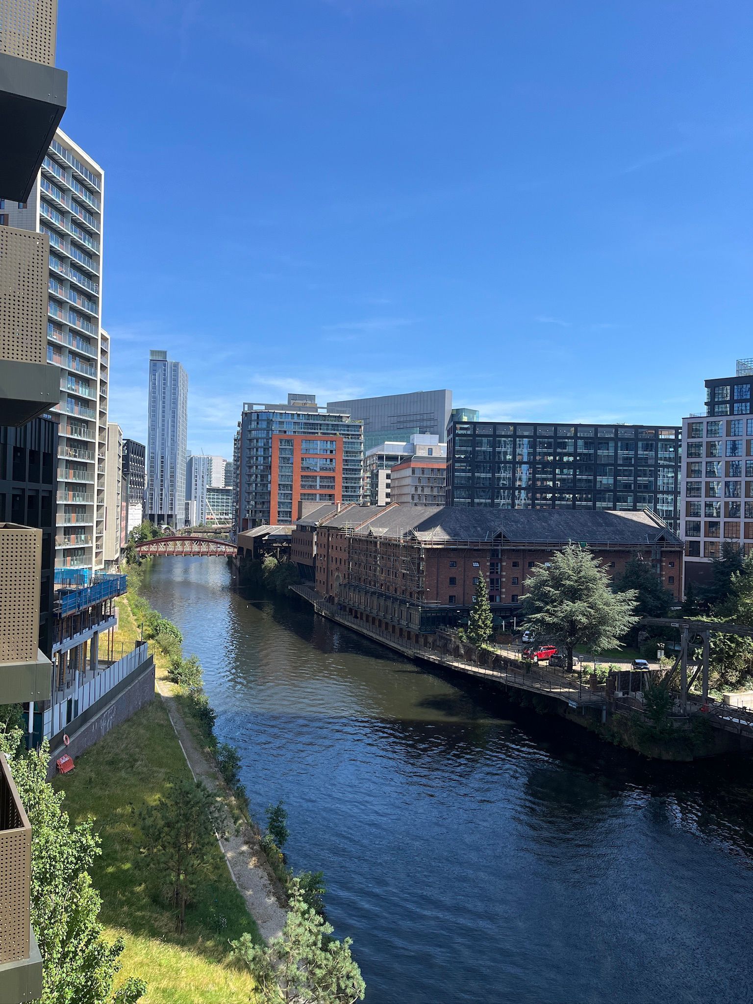 Canal with buildings on both sides under a clear blue sky.