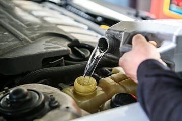Mechanic Pouring Water For Cooling System — Radiator Repair In Billings, MT