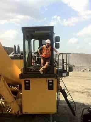 Man Riding Excavator — Tuscaloosa, AL — Hank's Auto Glass, Inc.
