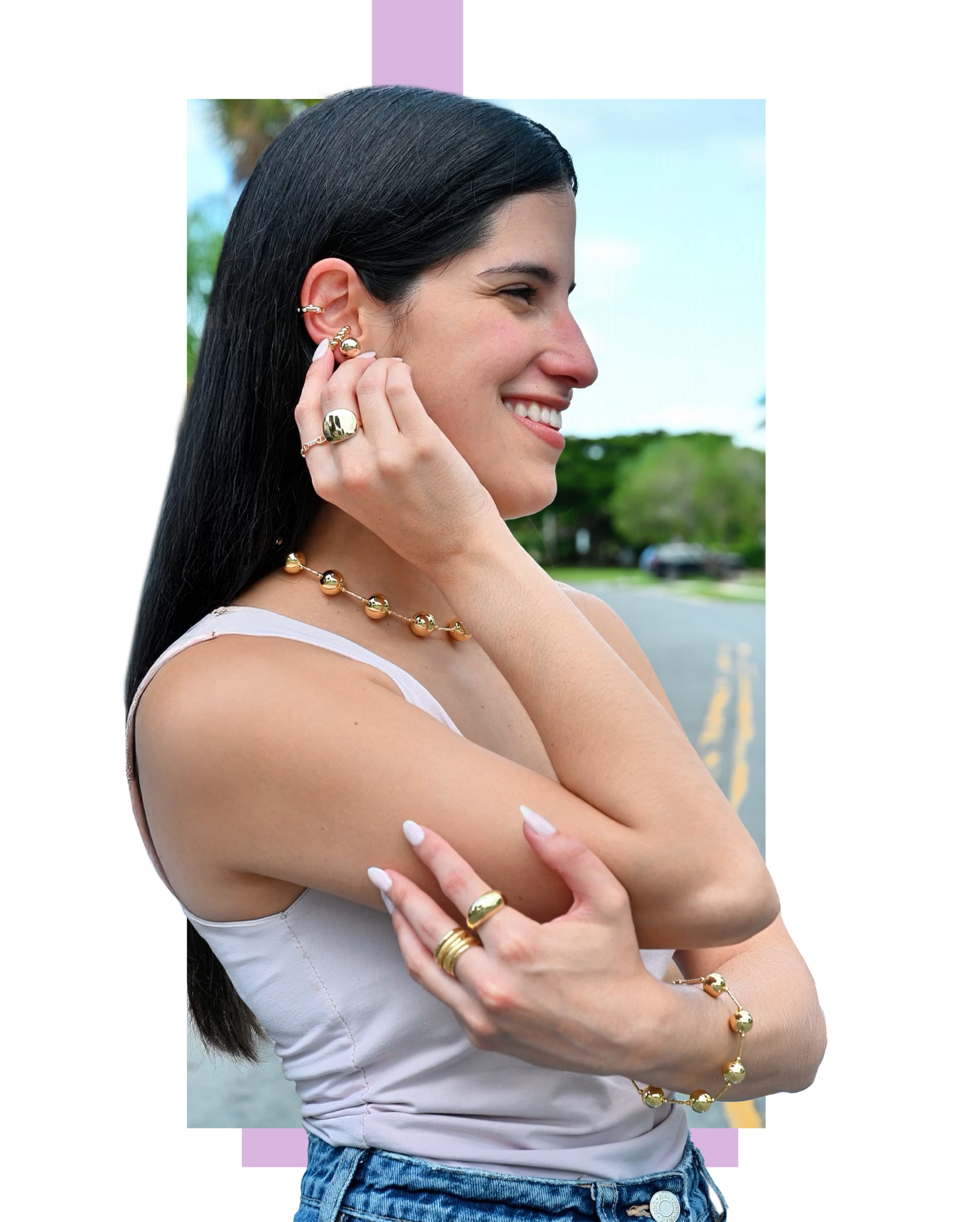 A woman is wearing a necklace , bracelet , and ring.