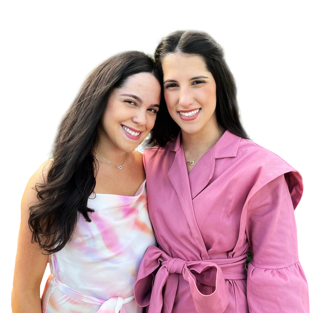 Two women are posing for a picture and one is wearing a pink jacket