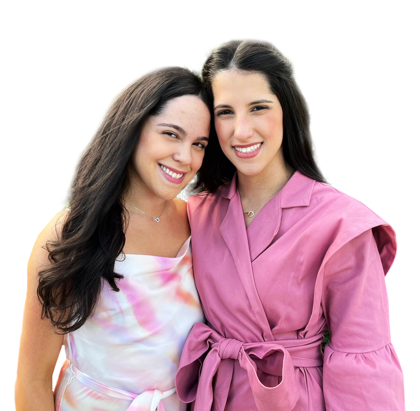 Two women are posing for a picture and one is wearing a pink jacket