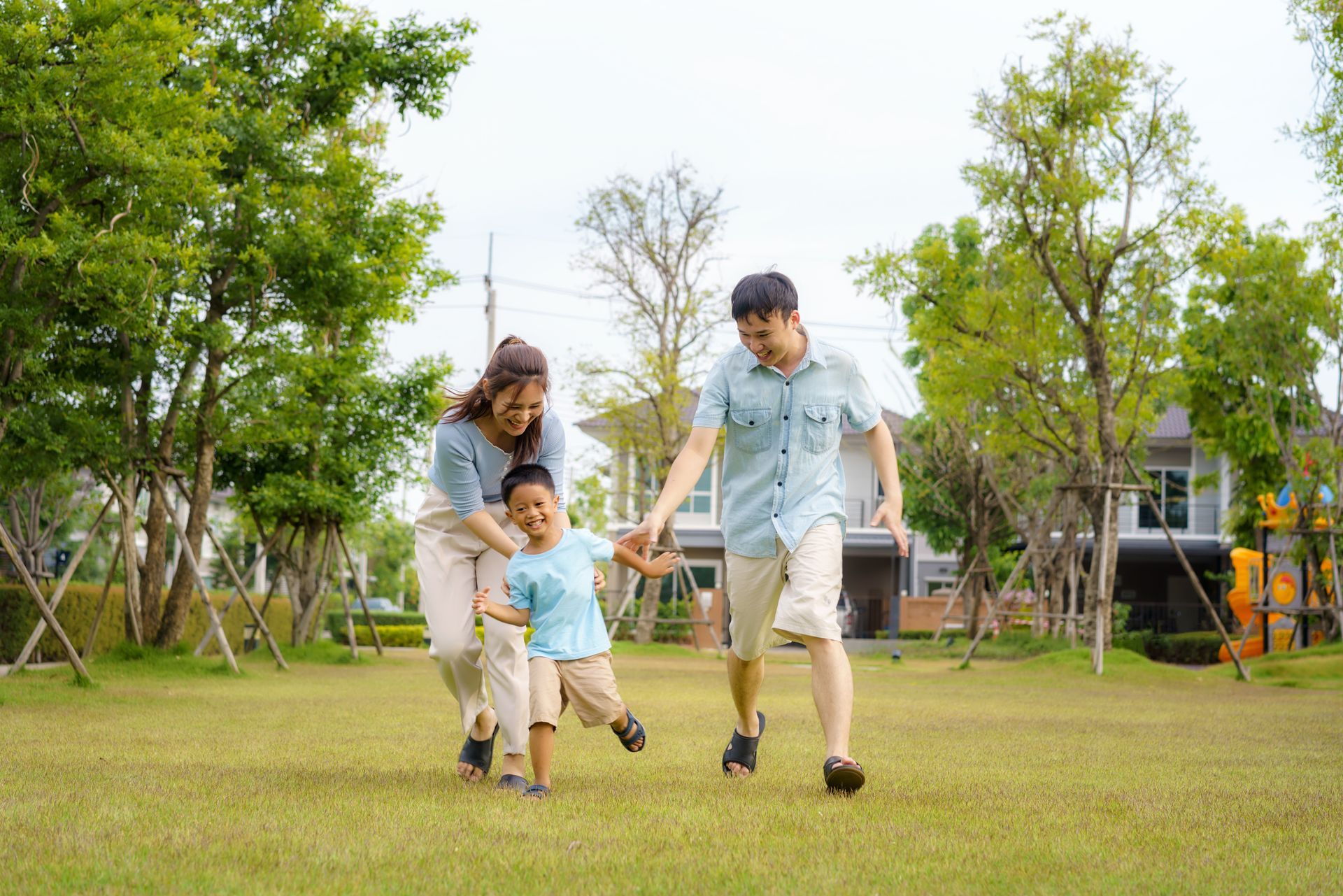 A group of people are walking down a path in a park.